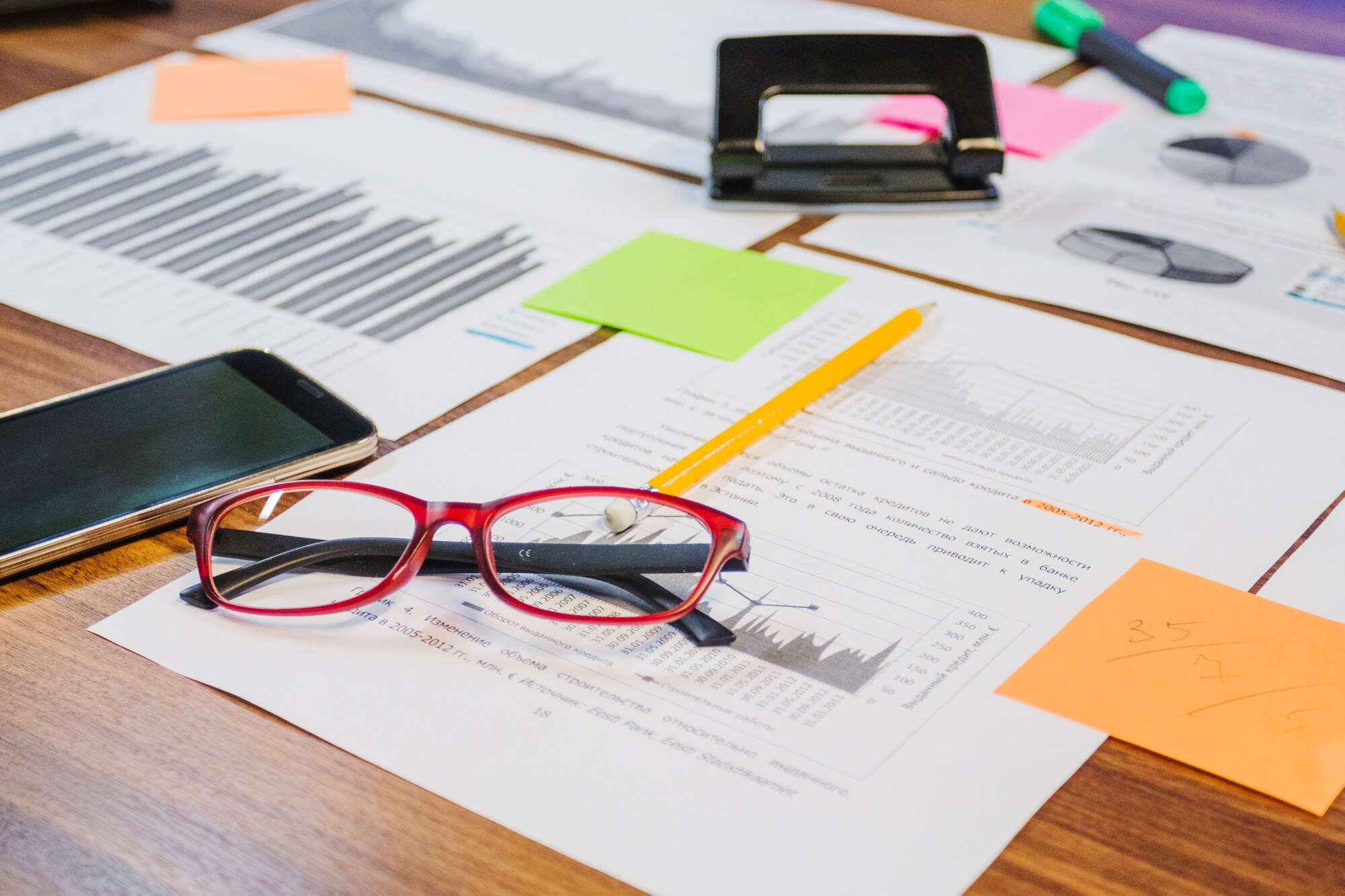 Tax documents, financial charts, and glasses on a professional desk